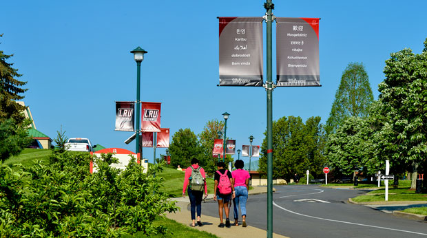 Three La Roche University female students walking on campus to class