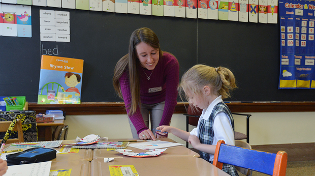 Student teacher at La Roche interacts with grade-school student in the classroom
