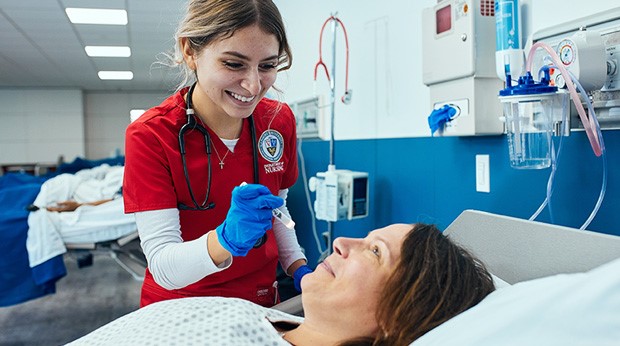 Student in La Roche University's Entry Level MSN program assess a patient.