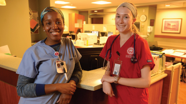 Grad nursing students at nursing station in hospital
