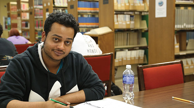 Student sitting at Wright Library Table