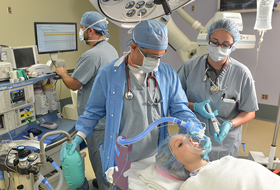 Doctor and nurse applying anesthesia procedure on patient..