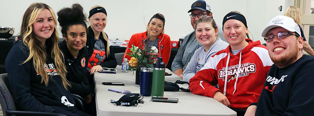 La Roche Alumni sitting at table in Campus Center Square