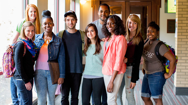 A group of La Roche University students stand in the hallway of Magdalen Chapel.