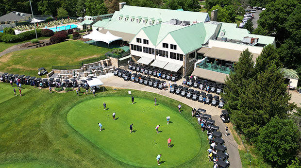 Aerial view of golfers on the putting green at a golf club.