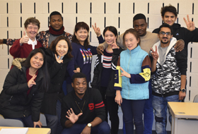 A group of students in the English as a Second Language program at La Roche University pose for a photo in the classroom