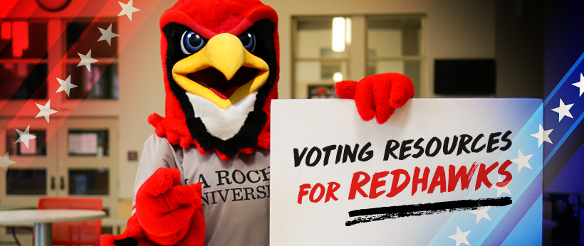 La Roche University's Redhawk holds sign in Campus Center Square that says Redhawk Voting Resources