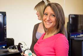 Two students using recording equipment at La Roche University. 