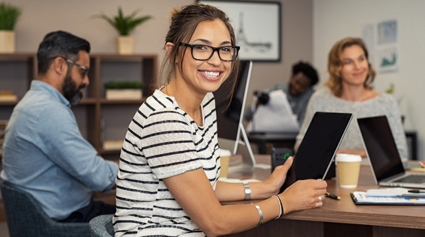 A woman works in an open office setting.