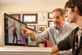 Professor with student at computer screen