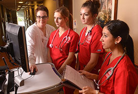 La Roche University nursing students in front of computer screen