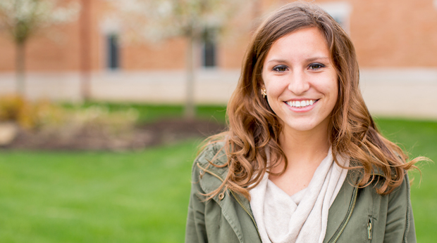 Female student at La Roche University stands outside of Bold Hall.