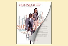 The Summer 2014 cover of the La Roche magazine. The cover photo shows a student sitting on a chair and another student standing next to him. Behind them there is a design element of multiple words.