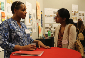 Two women talk and network in the Cantellops Art Gallery during La Roche University’s Business Etiquette Dinner.