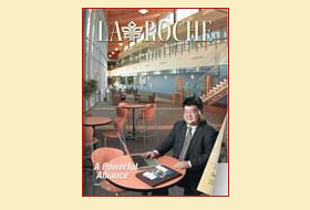 The cover of the Winter 2005 issue of the La Roche magazine. A University administrator sits in a hallway/lounge area of a conference center.