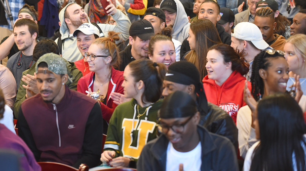 A crowd of La Roche University students seated at an event on campus. Some students are laughing and clapping.