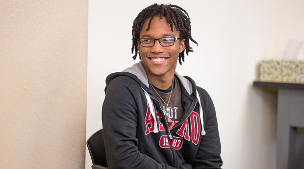 A student sits on a chair in a classroom at La Roche University.