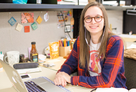 A La Roche University interior design student seated at a personal workstation in the design studio.