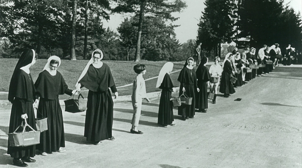 Known as the "Basket Brigade," Sisters and friends transport books by baskets from Providence Heights to the new Wright Library.